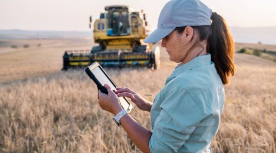 Farmer in field with tablet. | Newsreel