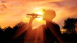 Man drinking in hot sun. | Newsreel