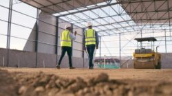 Builders looking at warehouse construction. | Newsreel