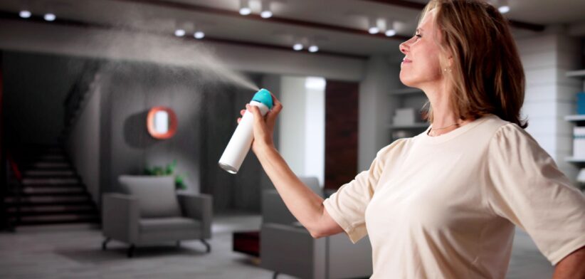 Woman spraying air freshener. | Newsreel