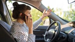 Woman on phone in car. | Newsreel