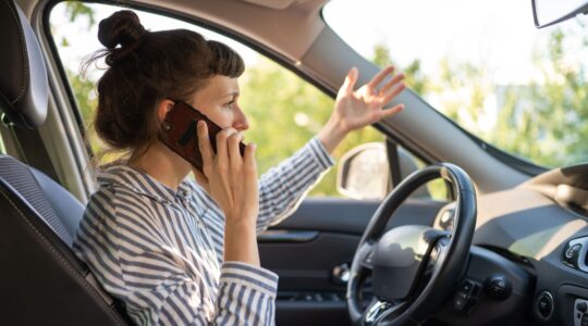 Woman on phone in car. | Newsreel