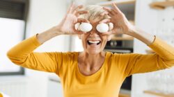 Woman holding eggs in front of eyes. | Newsreel