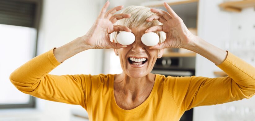 Woman holding eggs in front of eyes. | Newsreel