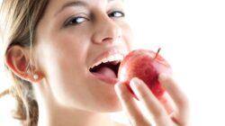 Woman eating apple. | Newsreel