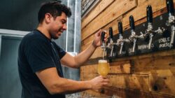 Man pouring a beer. | Newsreel