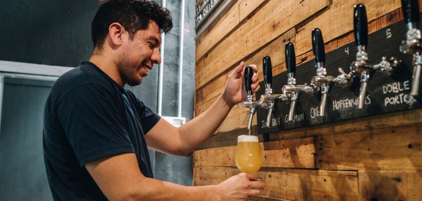 Man pouring a beer. | Newsreel