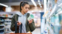 Woman looking at food label. | Newsreel