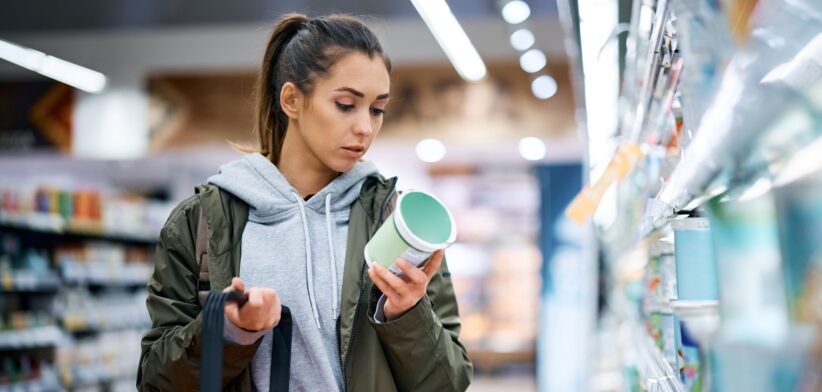 Woman looking at food label. | Newsreel