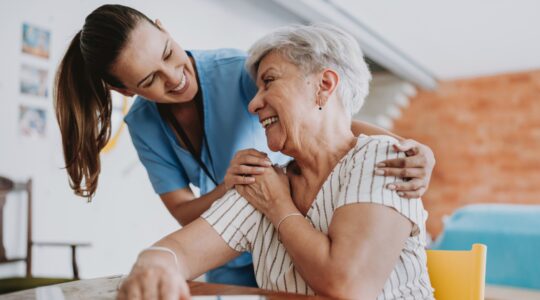 Elderly woman and care provider. | Newsreel