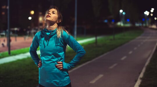 Woman exercising at night. | Newsreel