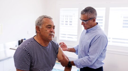 Aboriginal senior receiving an injection. | Newsreel