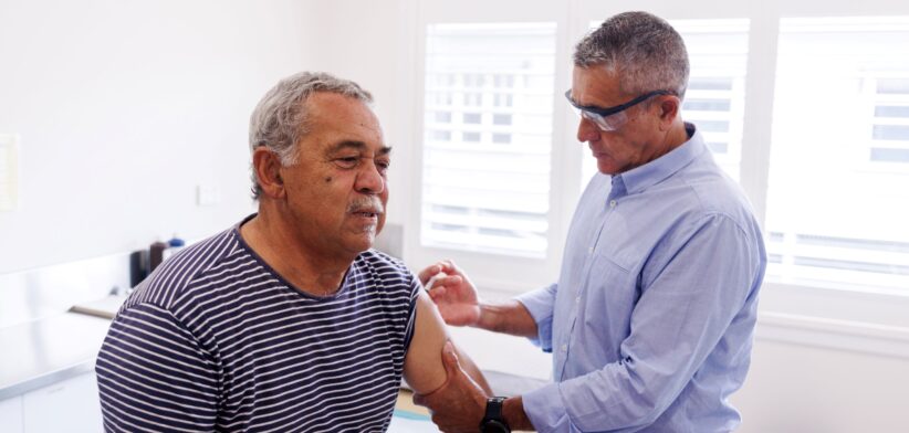 Aboriginal senior receiving an injection. | Newsreel
