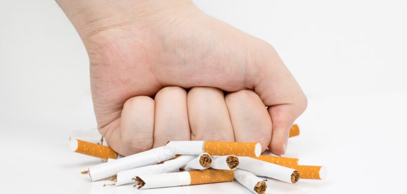 Fist crushing cigarettes. | Newsreel