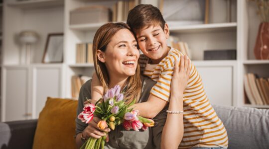 Mother and son with flowers. | Newsreel