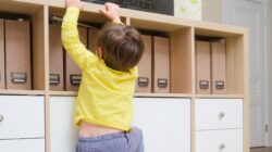 Young boy climbing cupboard. | Newsreel
