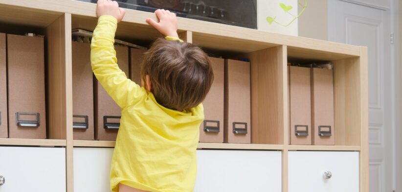 Young boy climbing cupboard. | Newsreel