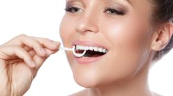 Woman using floss pick. | Newsreel