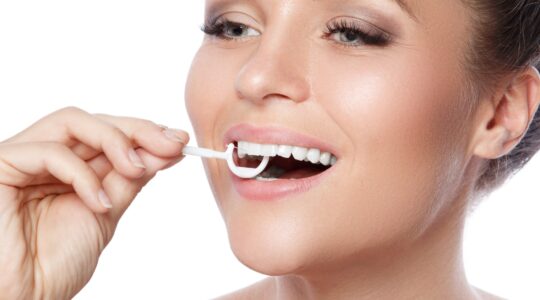 Woman using floss pick. | Newsreel