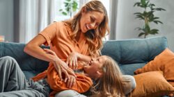 Mother tickling child. | Newsreel