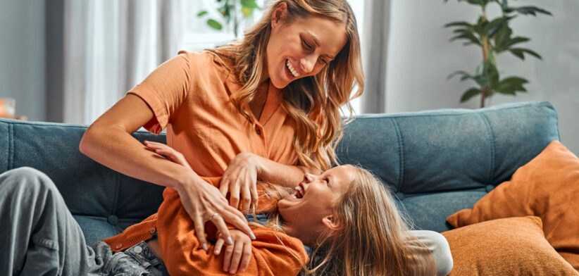 Mother tickling child. | Newsreel