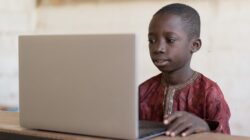 African child on computer.