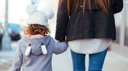 Mum and child holding hands. | Newsreel