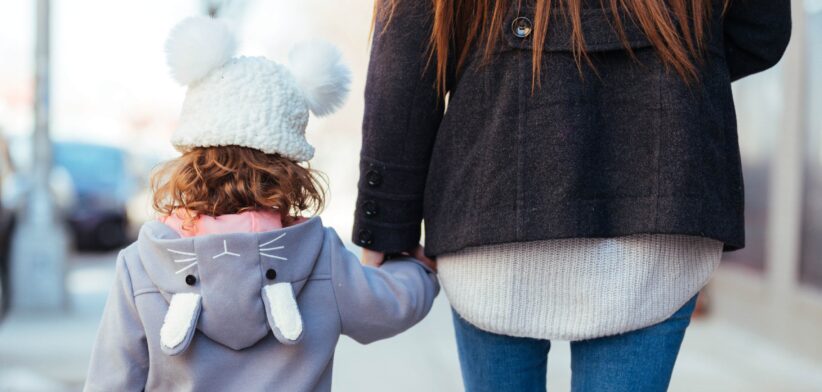 Mum and child holding hands. | Newsreel