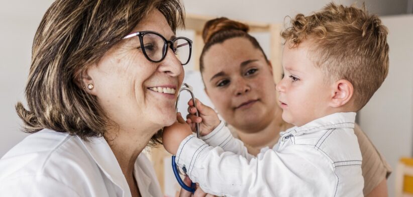 Doctor with young child and mum. | Newsreel
