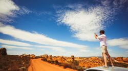 Man with phone in remote area.