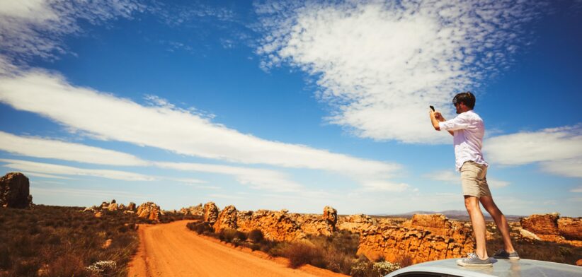 Man with phone in remote area.