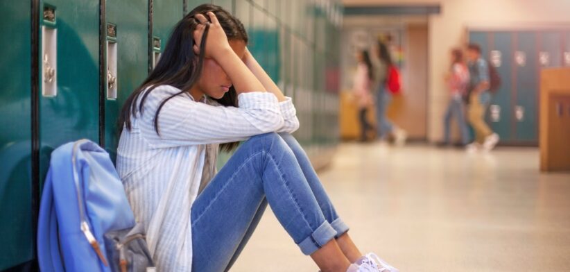 Teenage girl student upset at school.
