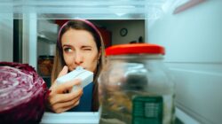 Woman test milk in fridge. | Newsreel