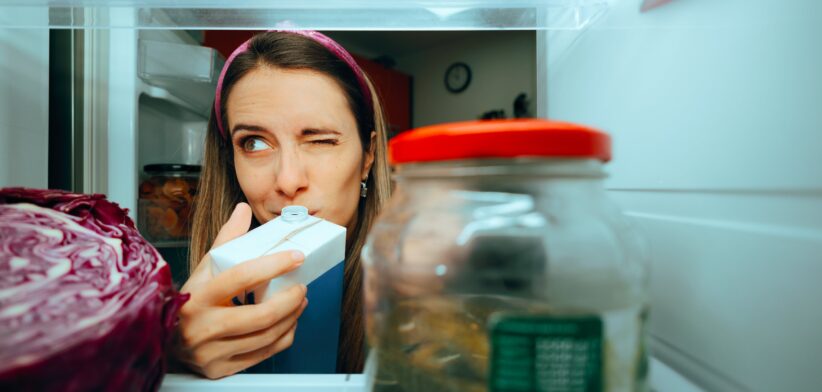 Woman test milk in fridge. | Newsreel