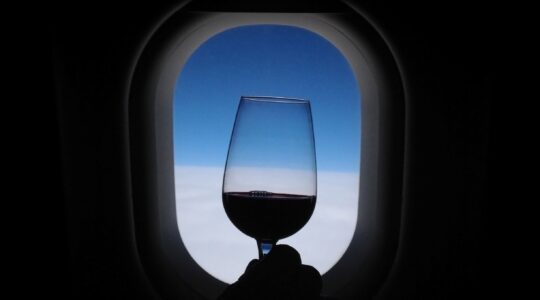 Glass of wine on plane.