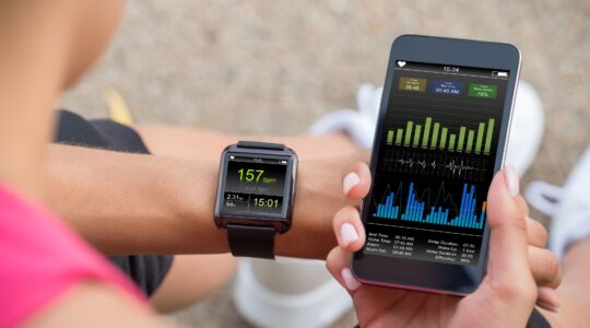 Woman checking data after exercise. | Newsreel