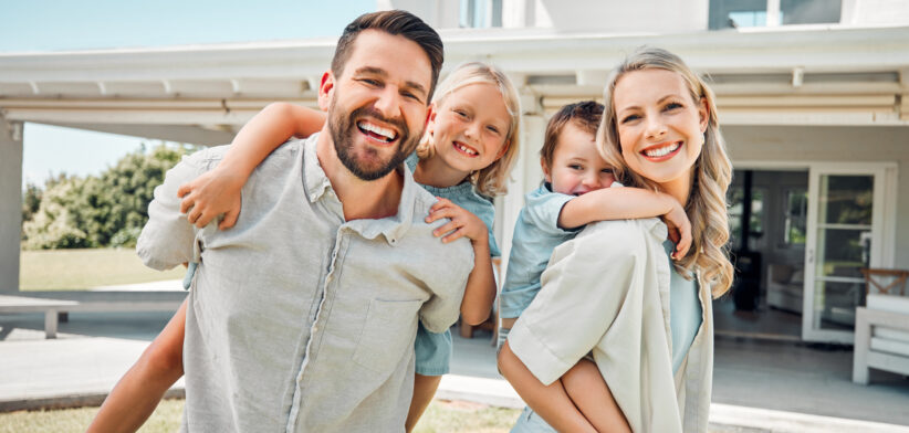 Portrait of a happy carefree caucasian family bonding and relaxing together in the garden or backyard at home. Loving parents carrying their smiling playful son and daughter to enjoy piggyback rides