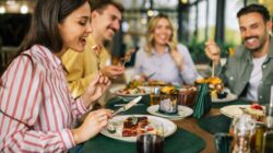 Group dining out at restaurant. | Newsreel