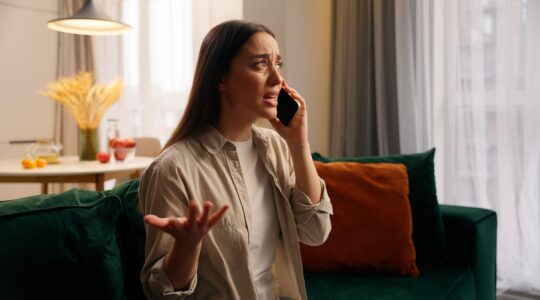 Woman upset on phone. | Newsreel