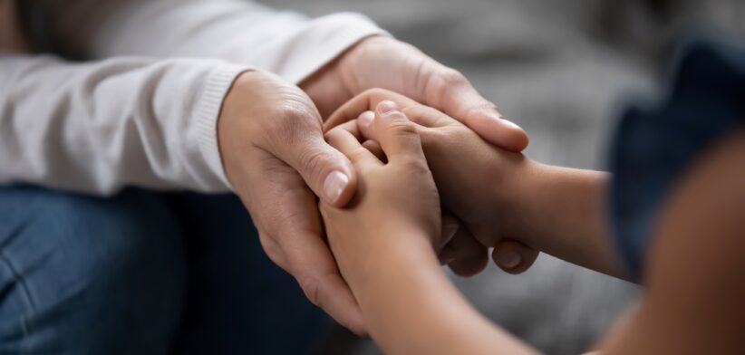 Adult and child holding hands. | Newsreel
