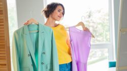 Women admiring clothes. | Newsreel