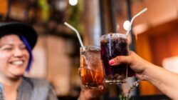 Couple cheersing with soft drink. | Newsreel