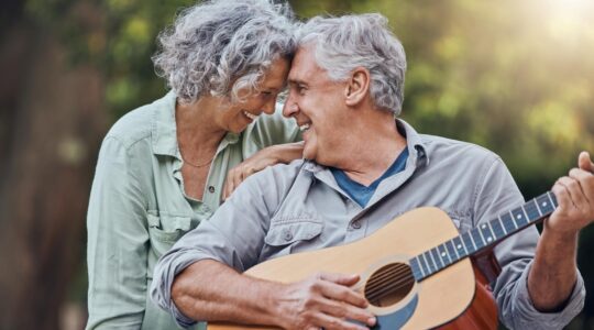 Elderly man playing guitar. | Newsreel