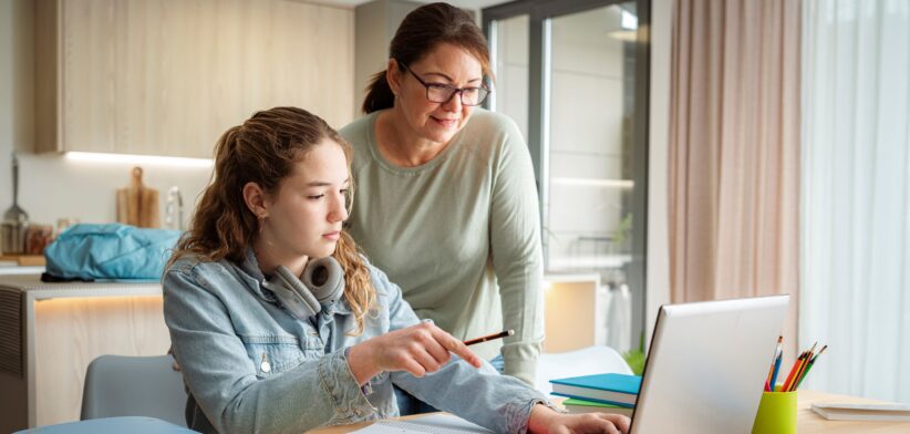 Parent helping child with school work.