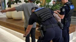 Police wanding a person for knives. | Newsreel