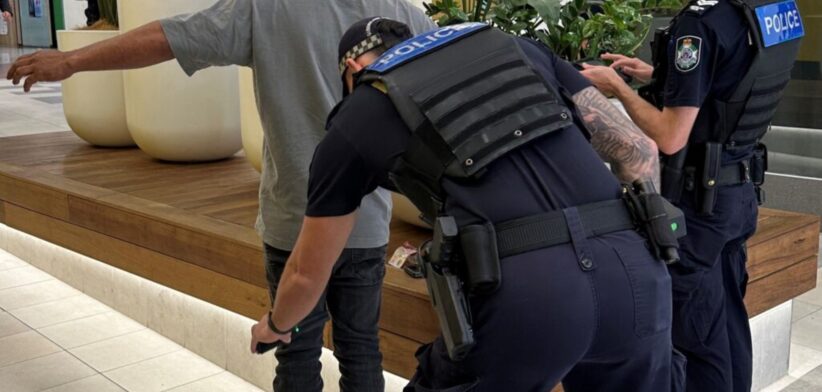 Police wanding a person for knives. | Newsreel