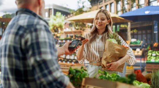 Woman buying groceries with mobile phone.