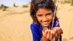 Young child drinking water. | Newsreel