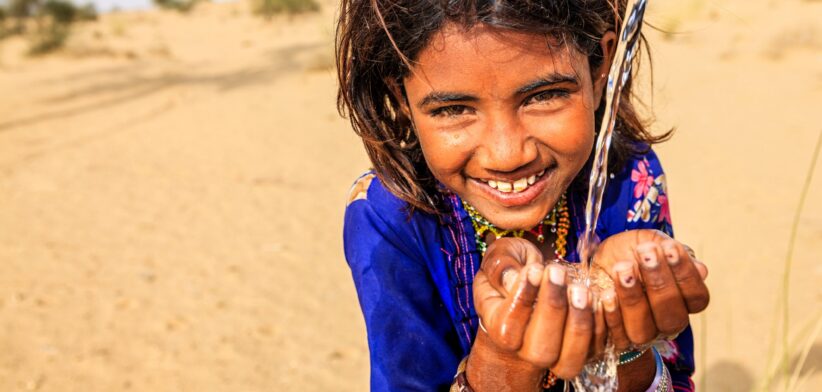 Young child drinking water. | Newsreel