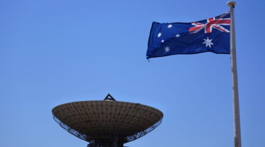 Satellite dish and Australian flag. | Newsreel
